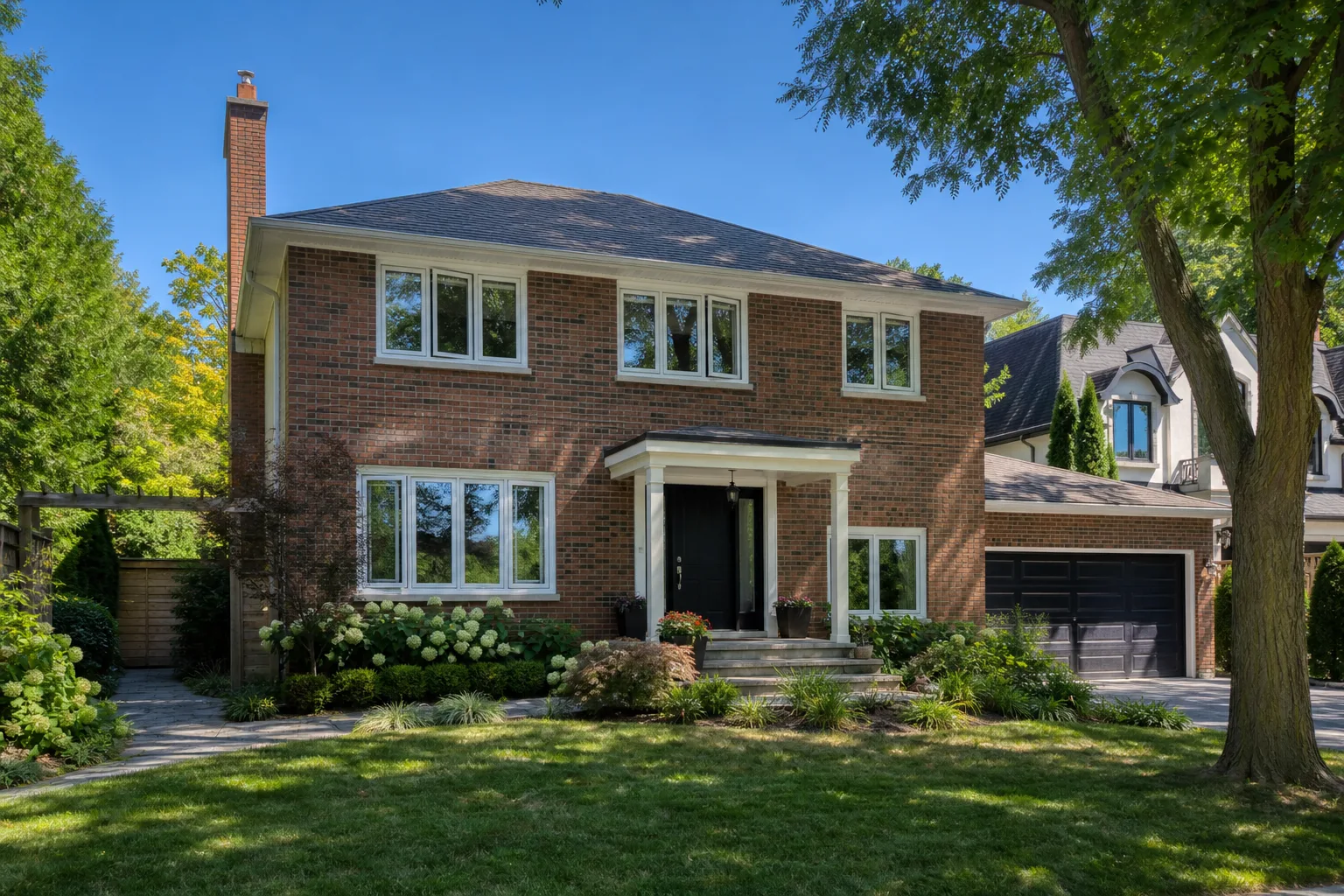 White vinyl casement windows on a two-storey brick home in Burlington, Ontario