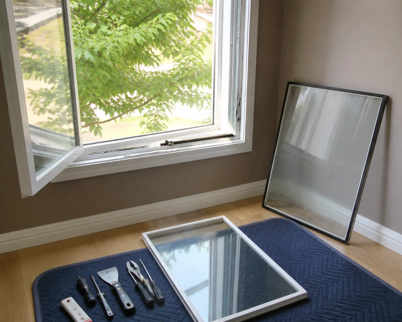 Old fogged double pane glass unit removed from a window next to a new clear sealed unit