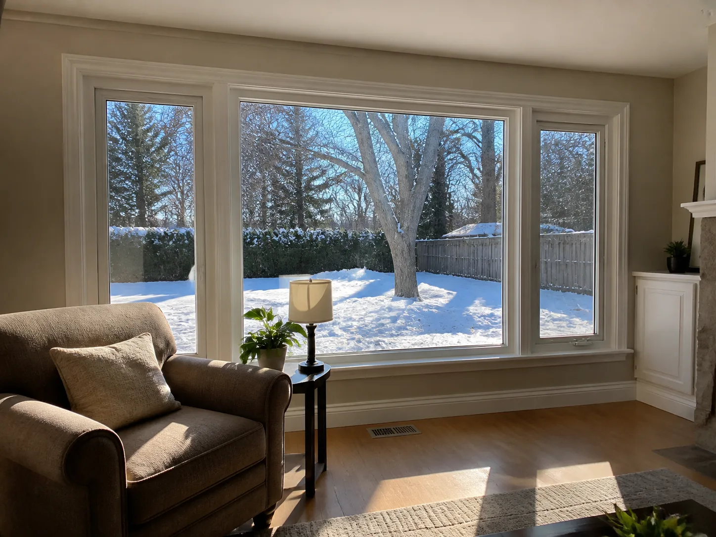 Bright family room on a snowy winter day with new white vinyl casement and picture windows